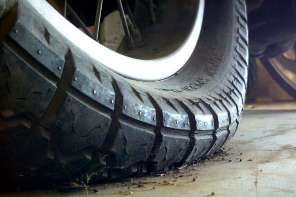 An under-inflated motorcycle tyre